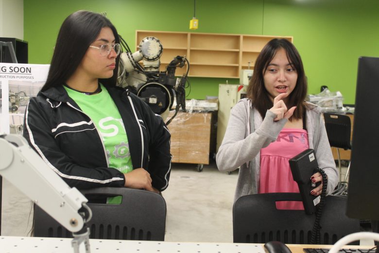 Ariana Fiel, 18, (right) a senior on the Southwest Engineering Team runs a robotics demonstration with her teammate, sophomore Laura Davis, 15.