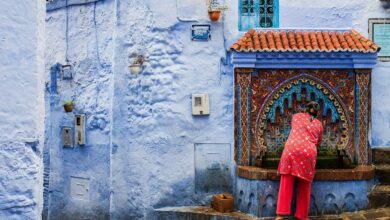 woman collecting water from a fountain chefchaouen morocco. photo miguel adobestock.com .jpg